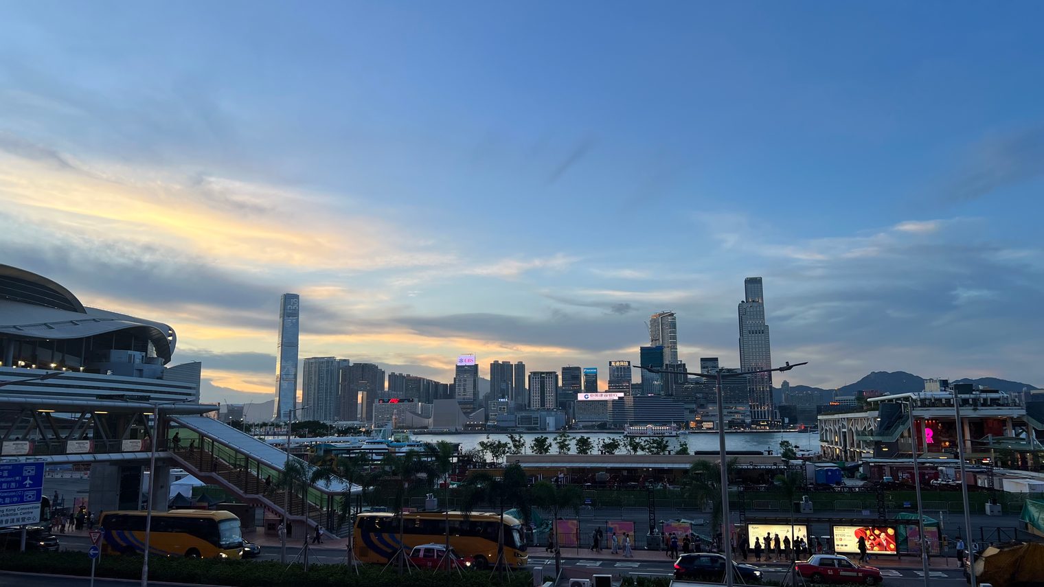 The same spot at dusk, a band of gold along the horizon and the towers across the water in silhouette
