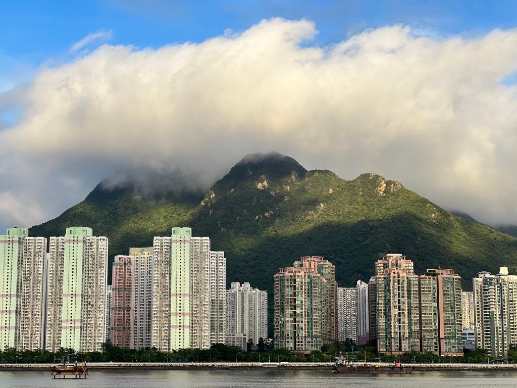 A great mass of cloud sitting on top of Ma On Shan, sunlight bringing out the green of its slopes