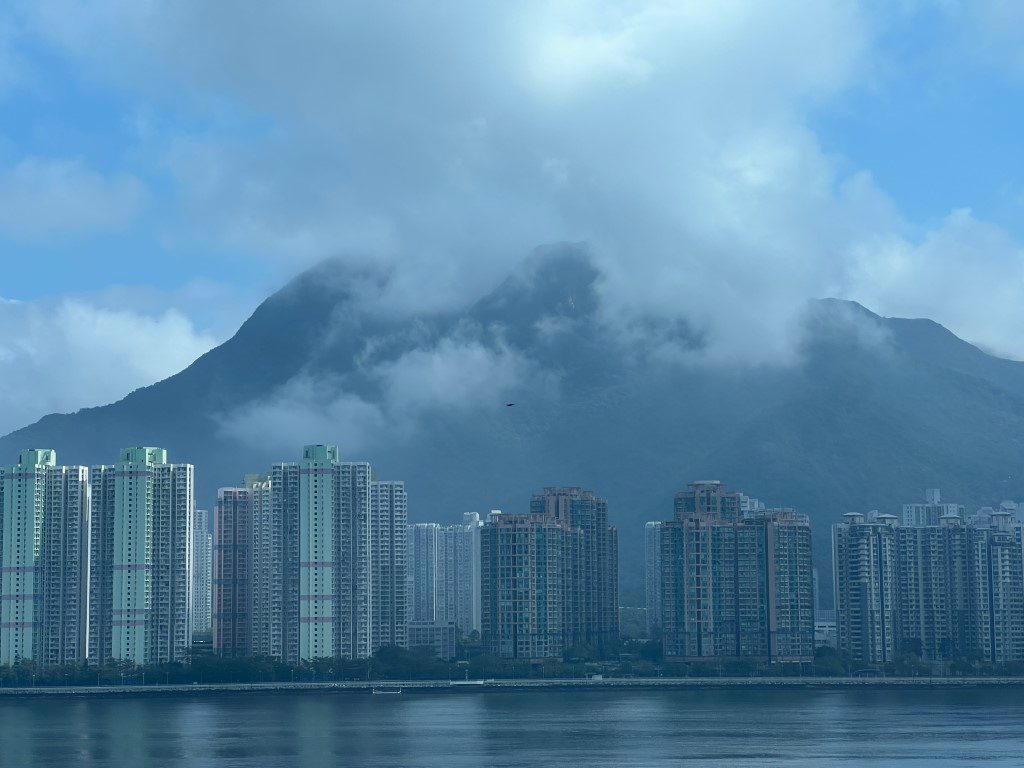 Cloud wrapped around the peaks of Ma On Shan, with tower blocks and still water below